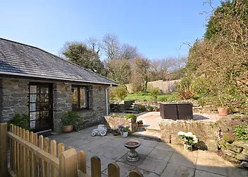 View towards the cottage and enclosed garden with seating