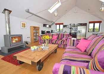 Open plan lounge area with woodburner 