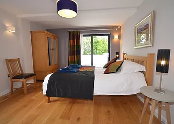 King-size bedroom with access out onto front patio area