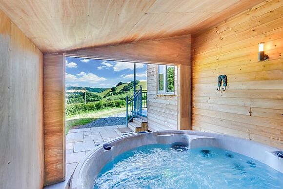 A hot tub lodge with Brecon Beacons views gives you the valley to yourselves