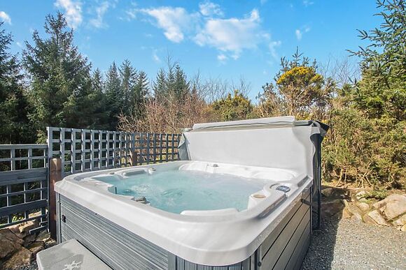 A woodland log cabin with a private hot tub and sauna near the Solway coast