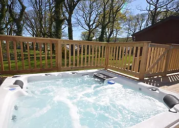 Sunken hot tub with iPod dock and views across the pond