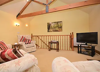 Lounge with stairs leading to bedrooms