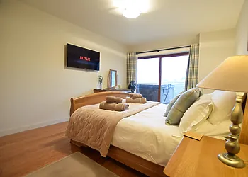 King-size bedroom on lower ground level with balcony