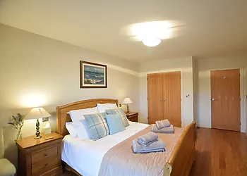 King-size bedroom on lower ground level with balcony