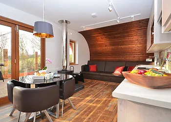 Open-plan lounge/kitchen/diner with woodbuner