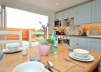 Kitchen/dining area with bi-fold doors to the decking