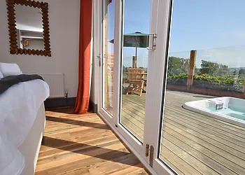 Bifold doors lead from the master bedroom to the decking
