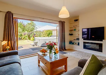 Lounge area with bi-fold doors leading to the garden