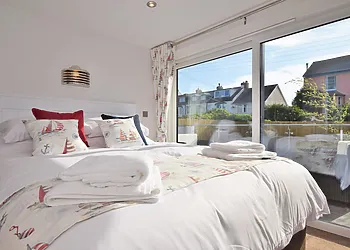 Double bedroom with en-suite and doors to decked area