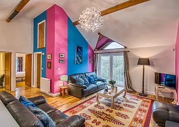 The fabulous lounge with wood burner, feature windows and TV