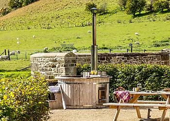 Wood fired hot tub with surrounding countryside views