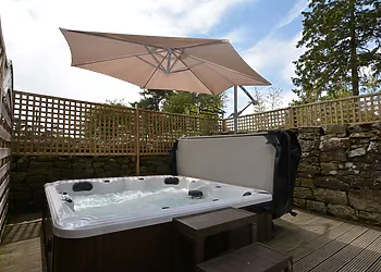 Indulge in the hot tub, straight off the bedroom, in the private garden