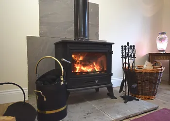The wood burner offers comfort and warmth in the lounge