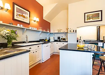 Traditional kitchen with island and warming Aga