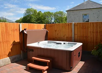 Private enclosed hot tub with seating area
