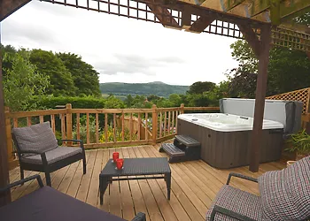 A beautiful spot to relax in with your own hot tub whilst looking out to Sugar Loaf mountain