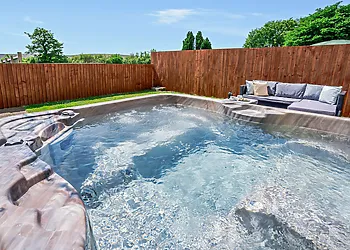 Take a dip in the private hot tub and savour the views