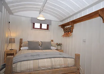 Cosy double bedroom with a woodburner