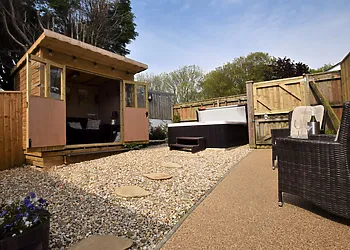 Enclosed area with private hot tub, summerhouse and seating