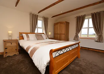 King-size mezzanine bedroom overlooking the surrounding countryside