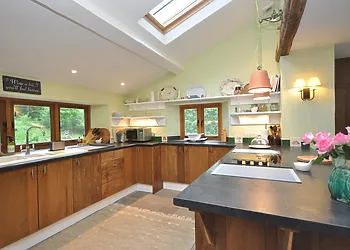 A stylish kitchen with woodland views