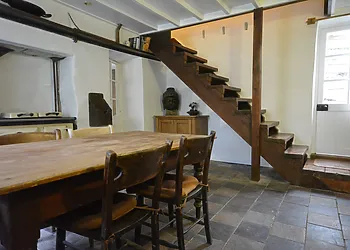 Rustic dining area with stairs to the first floor