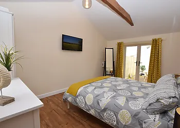 King size bedroom with doors onto the patio garden