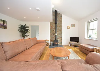 A stylish contemporary lounge area with wood burner