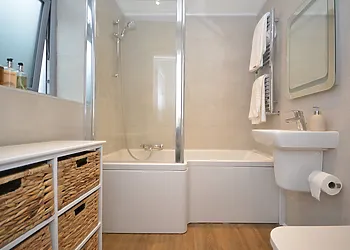 Family bathroom with shower over bath