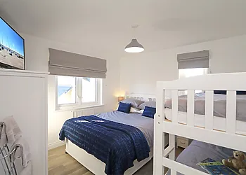 Bedroomwith a double bed, TV and bunk beds