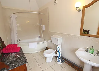 The master ensuite with shower over the bath