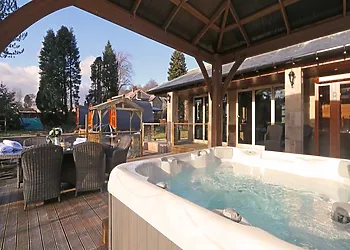 Enjoy time in your own hot tub with lovely garden views 