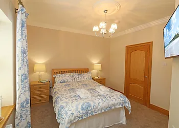 Double bedroom with TV and ensuite shower room