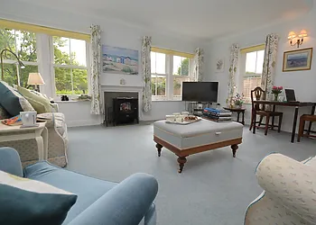 Relax in the bright and airy sitting room overlooking the pretty garden