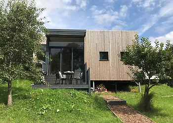 A stunning eco friendly lodge set in a streamside orchard with hot tub