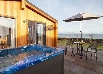 Enjoy the coastal bay views and relax in the hot tub 