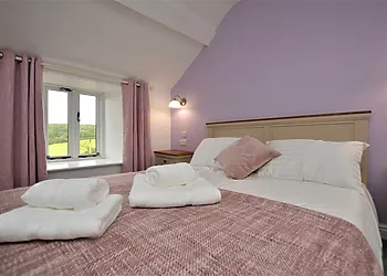 Spacious bedroom with TV and en-suite shower room