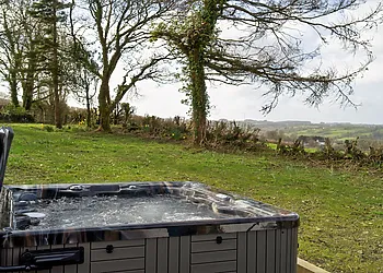 Relax and unwind in your own private hot tub as you soak up the views