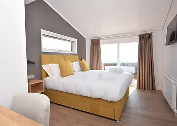 The spacious super king-size bedroom that can be made into a twin on request with en-suite bathroom Smart TV and patio doors