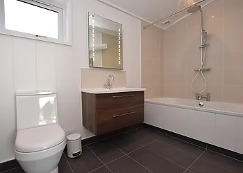 The spacious en-suite bathroom with shower over bath