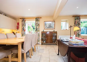 Open plan lounge/kitchen/diner with doors leading out to the garden