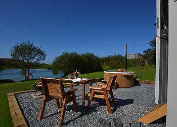 Sun-trap gravelled patio area overlooking the lake