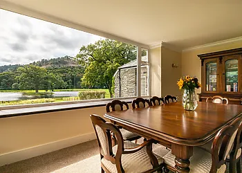 The second dining room overlooks the lake and is home to the library