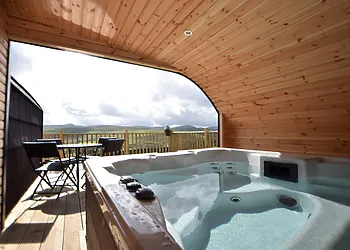Open fronted, housed hot tub with wonderful views
