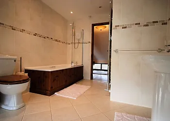 Very spacious bathroom with shower over bath