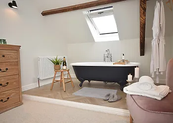Luxurious roll-top bath in the master bedroom