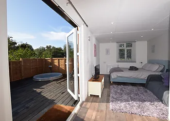 The open-plan studio-style interior opens out to the raised decking