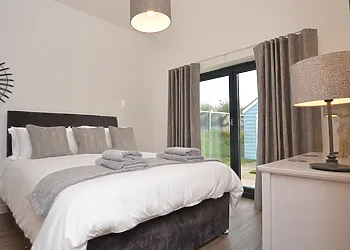 King-size bedroom with doors to outside