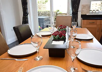 Lovely dining area with French doors leading out to the garden with hot tub